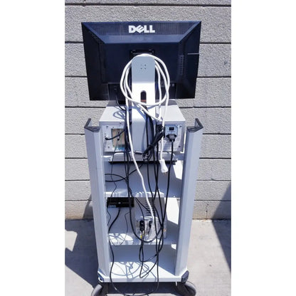 Black dell monitor mounted on a white wheeled cart with cables showcasing ellex eyecubed ultrasound biomicroscopy system as-is