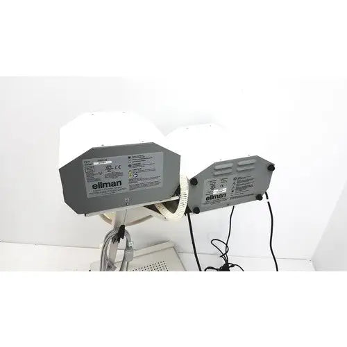 Gray eliman ceiling-mounted lighting fixtures with white hexagonal shades and black cords for surgical smoke evacuation