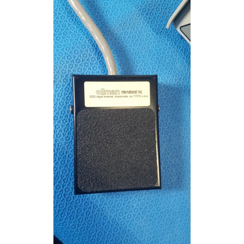 Black rectangular foot pedal with textured surface and ellman international inc label for ellman surgitron emc electrosurgical unit