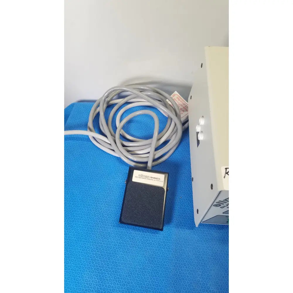 Black rectangular foot pedal with gray coiled cable for ellman surgitron emc electrosurgical unit control