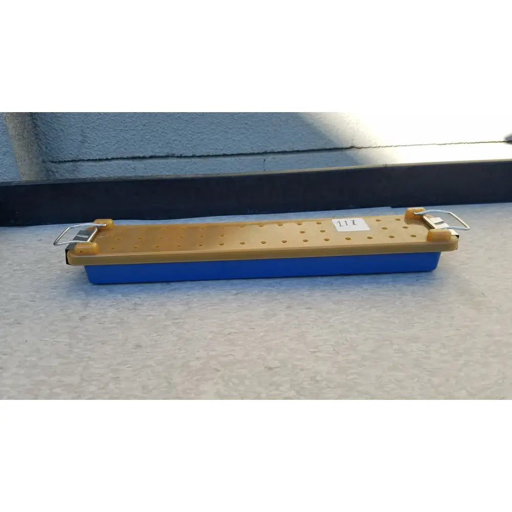 Blue and yellow plastic endoscope sterilization case tray with a perforated top surface for sterilization use