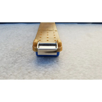 Yellow and blue plastic endoscope sterilization case tray with a metallic clasp for secure sterilization case use