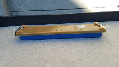 Blue and yellow plastic endoscope sterilization case tray with a perforated top surface for sterilization use