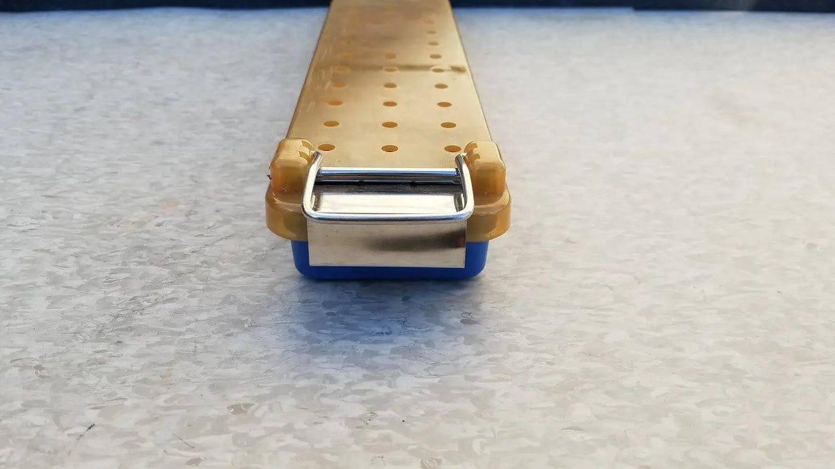 Yellow and blue plastic endoscope sterilization case tray with a metallic clasp for secure sterilization case use