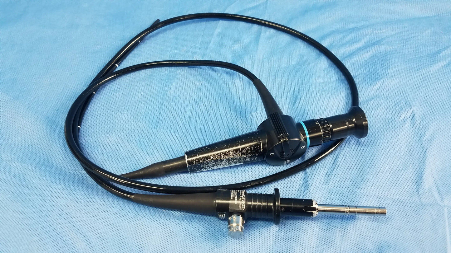 Black ENF-P4 endoscope rhino-laryngoscope flexible fiber optic with textured grip and metallic tip coiled on blue drape