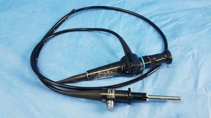 Black ENF-P4 endoscope rhino-laryngoscope flexible fiber optic with textured grip and metallic tip coiled on blue drape
