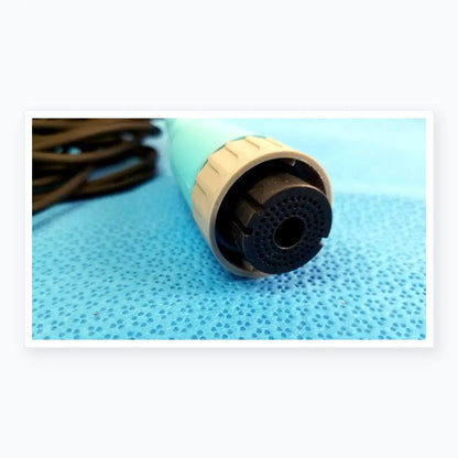 Light blue and beige plastic Ensite X EP catheter connector cable with black perforated nozzle for reuse medical equipment