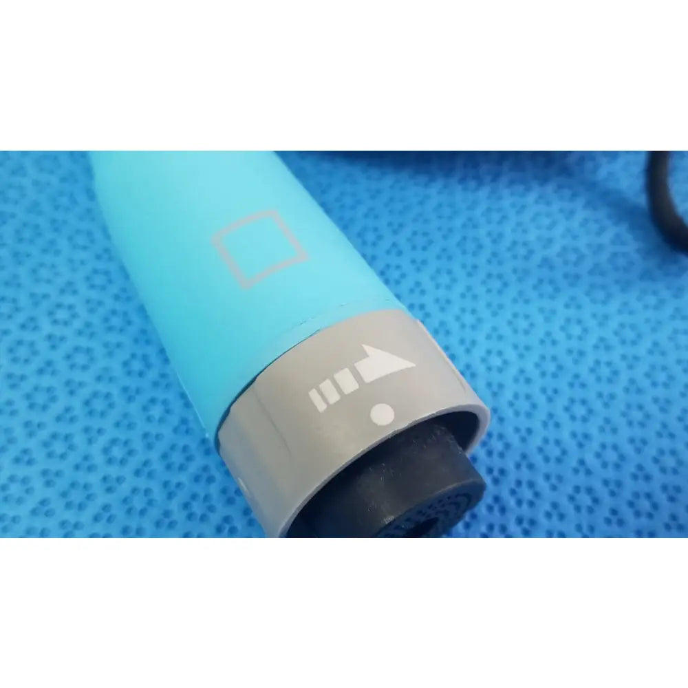 Light blue cylindrical hair dryer with gray power button and black nozzle shown with ensite x ep d-ens-l/r-cbl medical equipment catheter connector cable