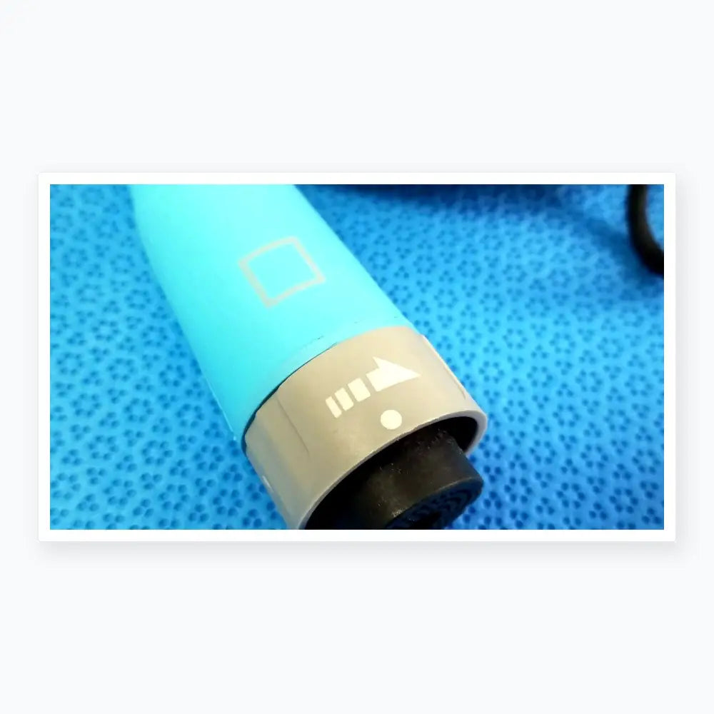 Light blue cylindrical hair dryer with gray power button and black nozzle shown with ensite x ep d-ens-l/r-cbl medical equipment catheter connector cable