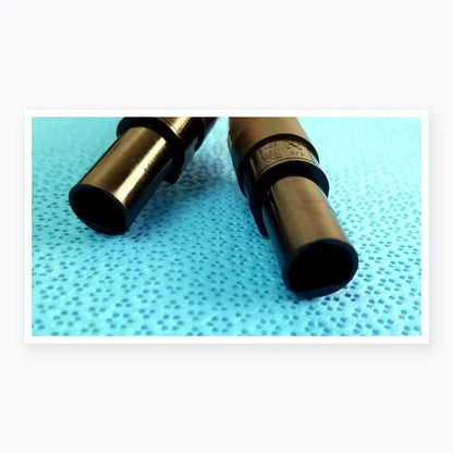 Black plastic cylindrical medical equipment with matte finish and engraved markings for reuse catheter connector cable
