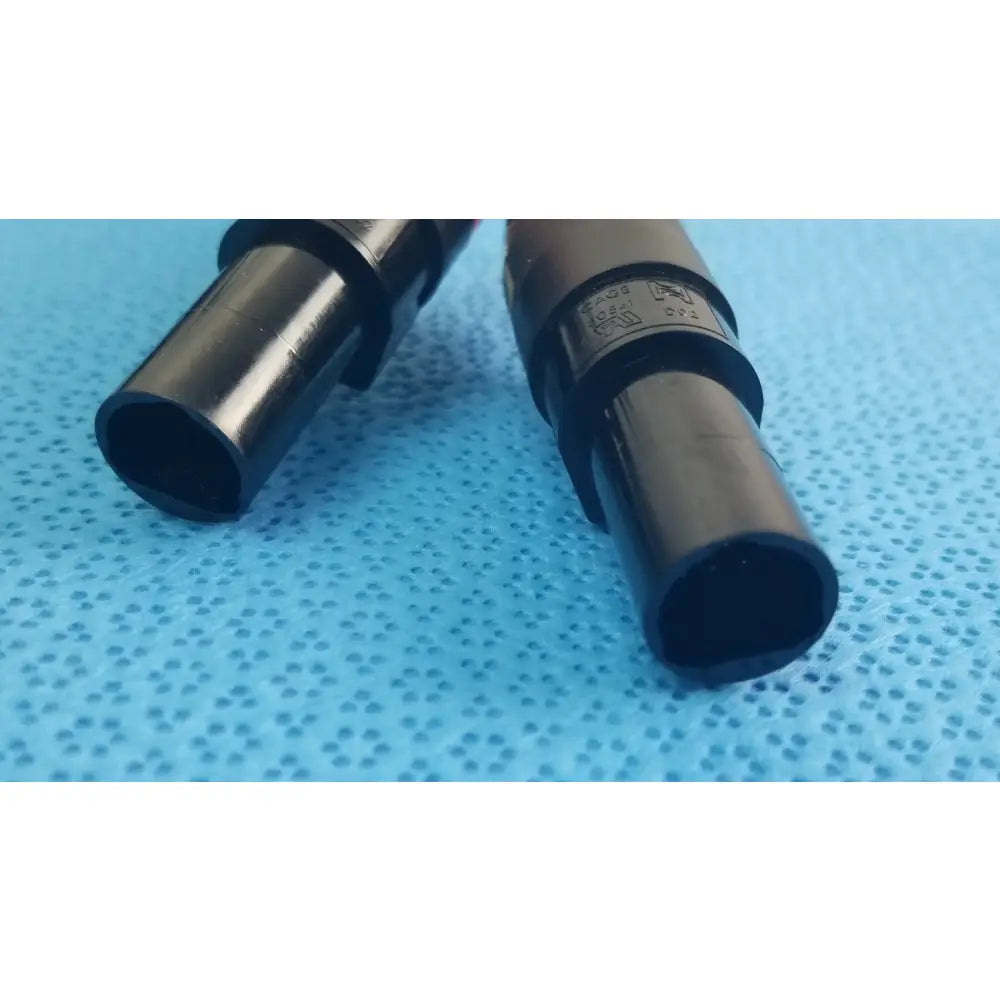Black plastic cylindrical medical equipment with matte finish and engraved markings for reuse catheter connector cable