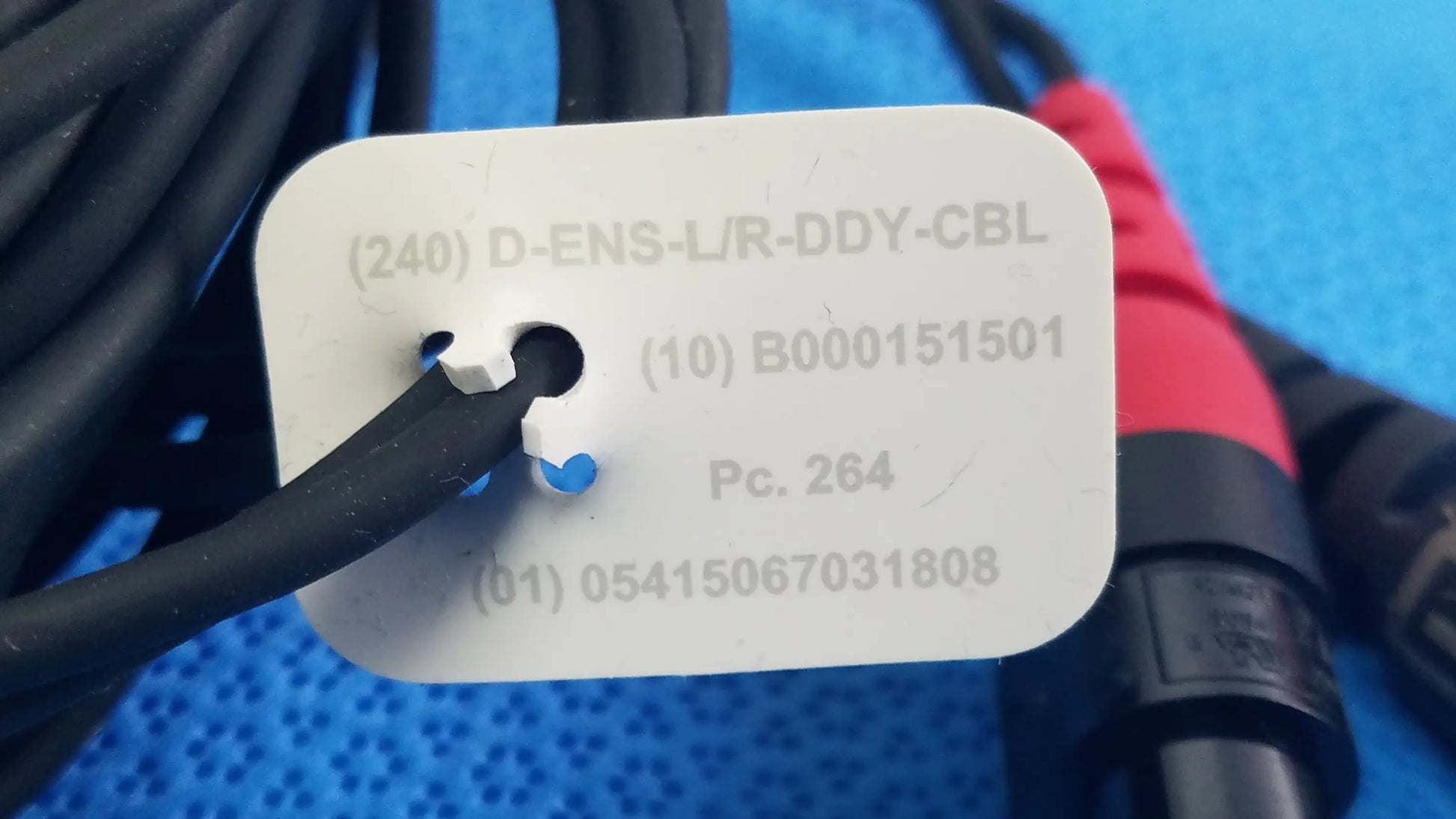 White rectangular label with black text attached to black cables of Ensite X EP D-ENS-L/R-DDY-CBL catheter connector cable for medical equipment