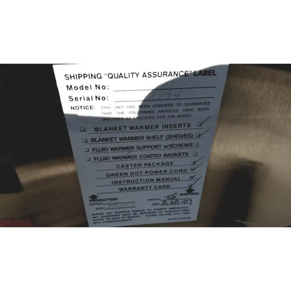 White paper label with model number serial number checklist and production date on the back of enthermics medical systems ec770 fluid warmer