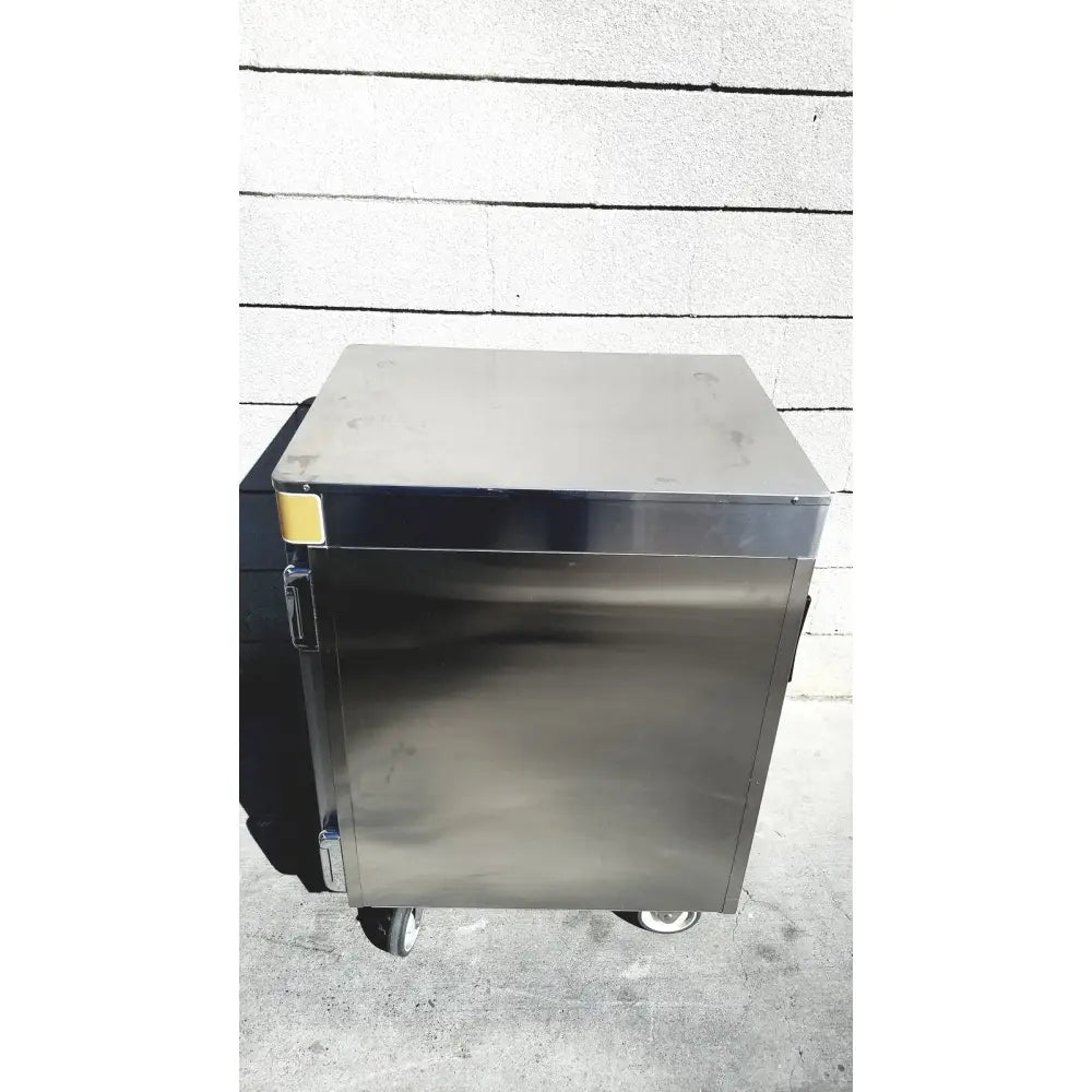 Stainless steel commercial food warmer on wheels with yellow label by enthermics medical systems ec770 fluid warmer