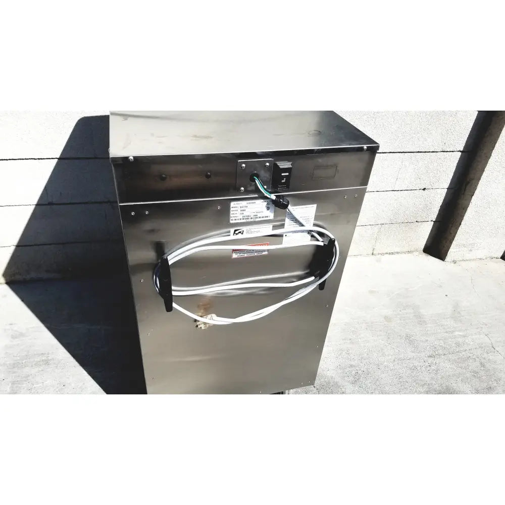Stainless steel industrial-grade commercial dishwasher with coiled white power cord and black outlet cover for enthermics medical systems ec770 fluid warmer