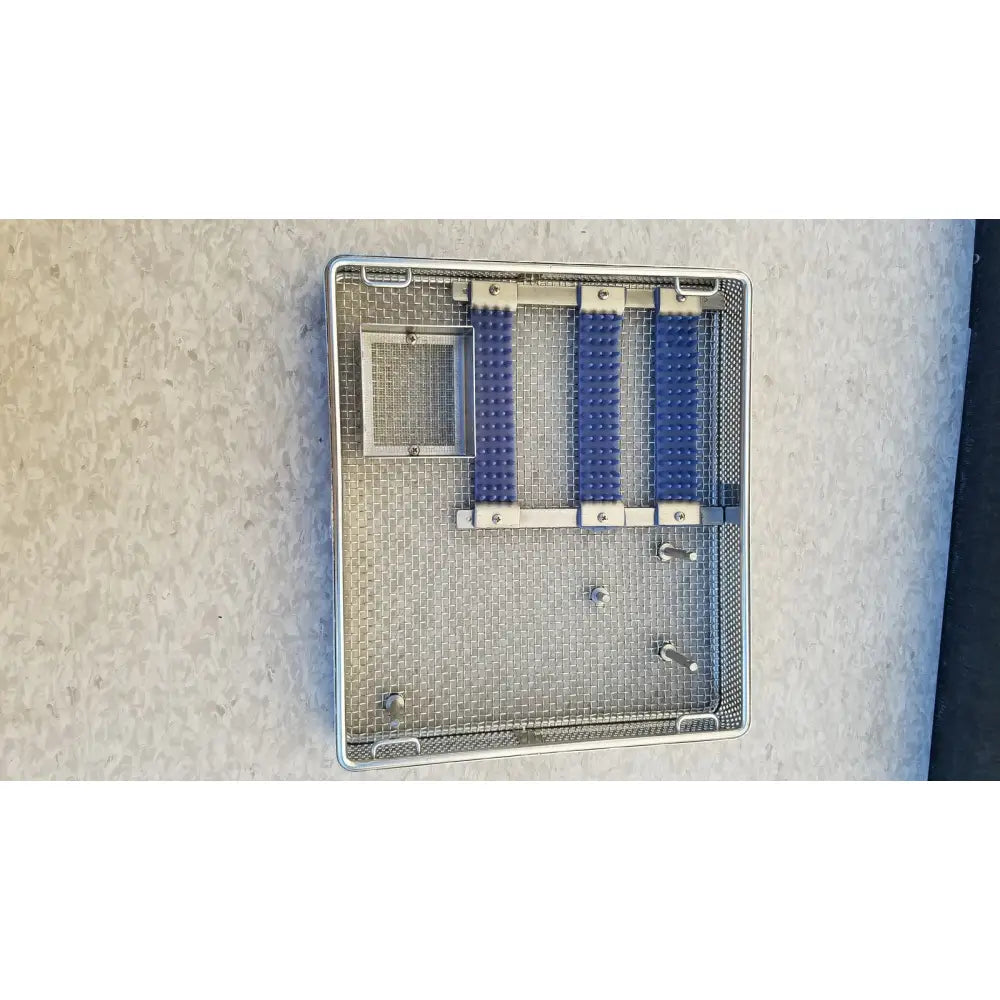 Entific sterilization case tray with three blue rubberized compartments and mesh interior made of stainless steel