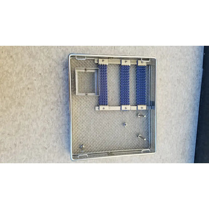Entific sterilization case tray with three blue rubberized compartments and mesh interior made of stainless steel