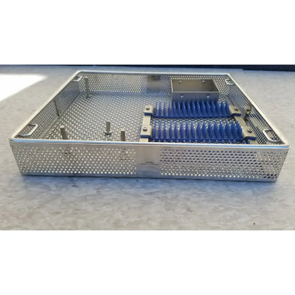 Stainless steel entific sterilization case tray with perforated mesh sides and a blue-bristled brush insert