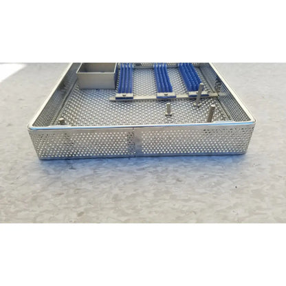 Entific sterilization case tray in stainless steel with perforated mesh and blue-handled surgical instruments