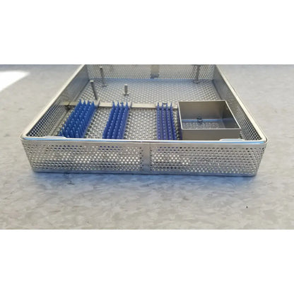 Stainless steel entific sterilization case tray with blue plastic inserts and a small metal compartment for instruments