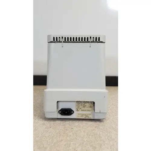 White plastic base of eppendorf 5415c centrifuge with power cord port and label on the back side for reuse medical equipment