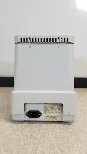 White plastic base of eppendorf 5415c centrifuge with power cord port and label on the back side for reuse medical equipment