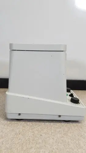 White plastic eppendorf 5415c centrifuge with black control knobs on the front panel for laboratory use