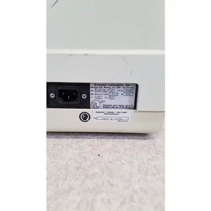 Back of white eppendorf 5415c micro centrifuge plastic device with black power input port and technical label