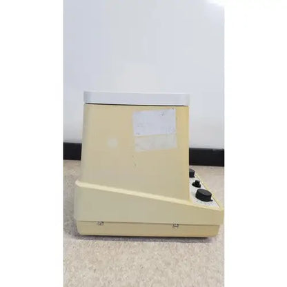 Beige plastic eppendorf 5415c micro centrifuge with white top and black control knobs for laboratory use