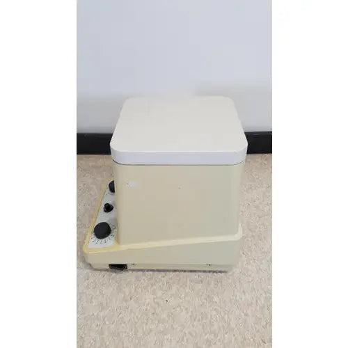 Cream-colored eppendorf 5415c micro centrifuge with rectangular design white lid and black control knobs