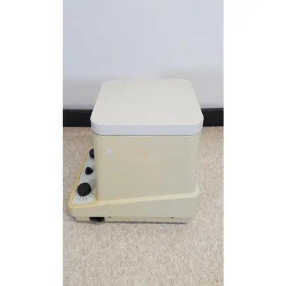 Cream-colored eppendorf 5415c micro centrifuge with rectangular design white lid and black control knobs
