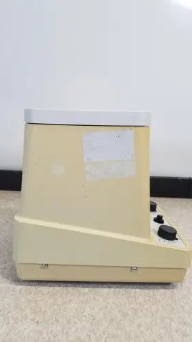 Beige plastic eppendorf 5415c micro centrifuge with white top and black control knobs for laboratory use