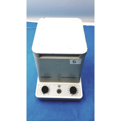 White and gray eppendorf centrifuge laboratory centrifuge model w250 with black knobs and green power indicator light