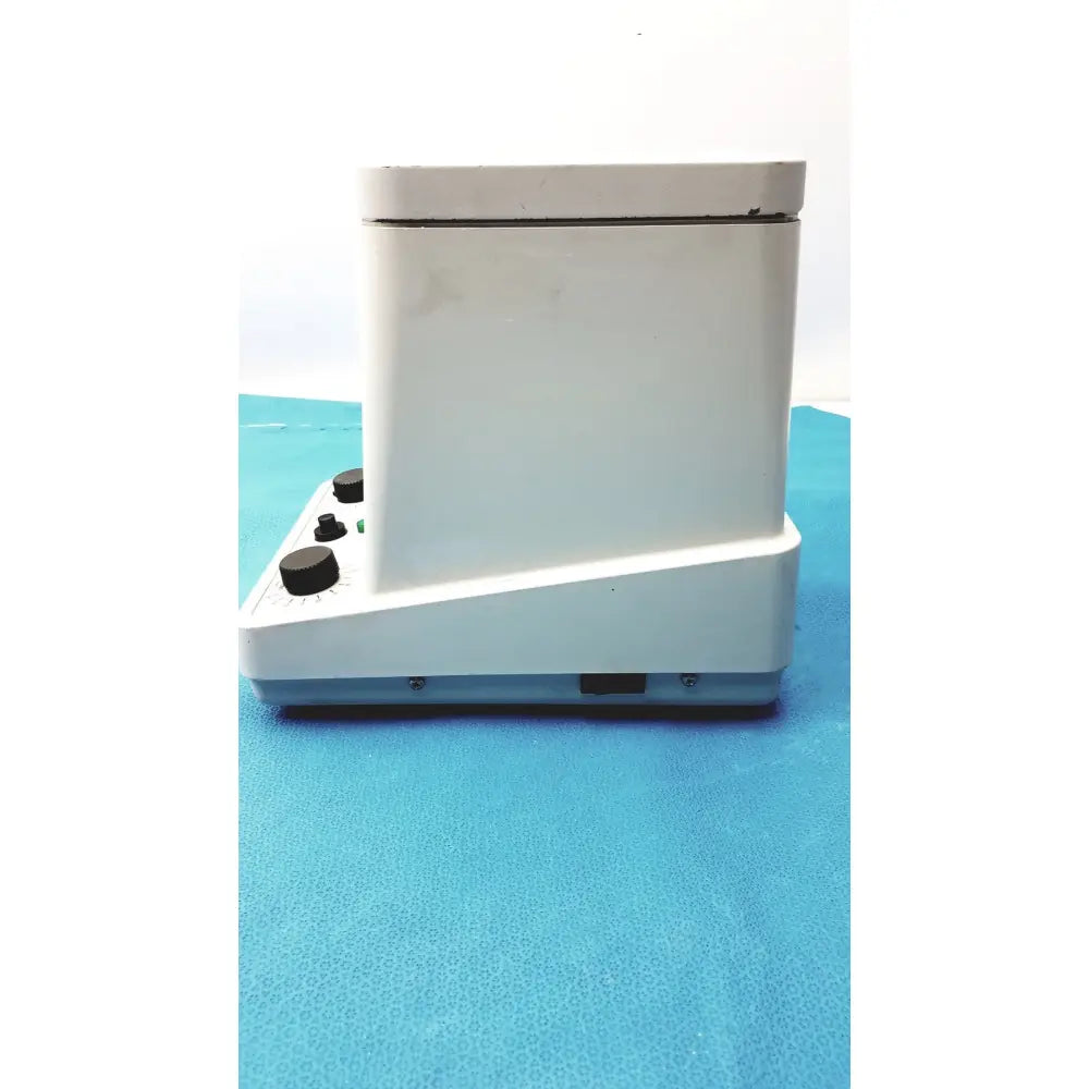 Eppendorf centrifuge laboratory model W250 with white body, black control knobs, and gray base for precise sample separation