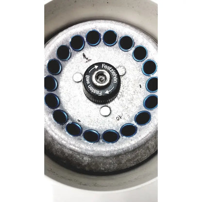 Silver metal eppendorf centrifuge laboratory rotor with central black knob and twelve circular wells for model w250
