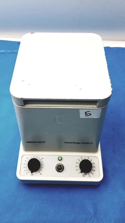 White and gray eppendorf centrifuge laboratory centrifuge model w250 with black knobs and green power indicator light