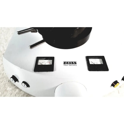 White zeiss microscope base with black dials and objective turret shown alongside eppendorf centriifuge 5415 r for reuse medical use