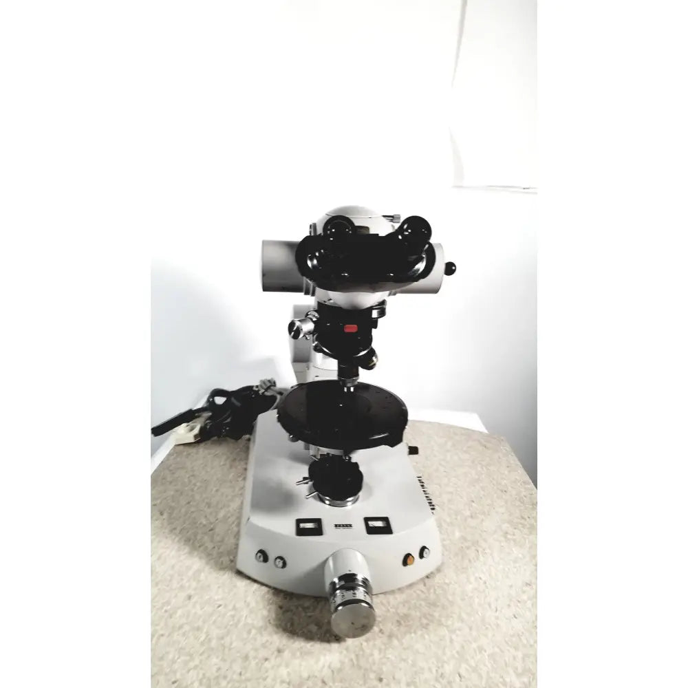 Eppendorf centriifuge 5415 r with white and black stereo microscope, dual eyepieces, rotating stage, and metallic knobs for reuse medical tasks