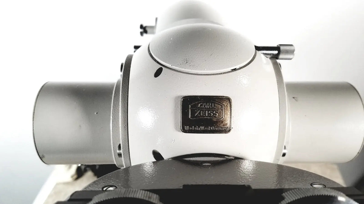 White and silver carl zeiss microscope with metallic brand plate featured in eppendorf centrifuge 5415 r for reuse medical applications