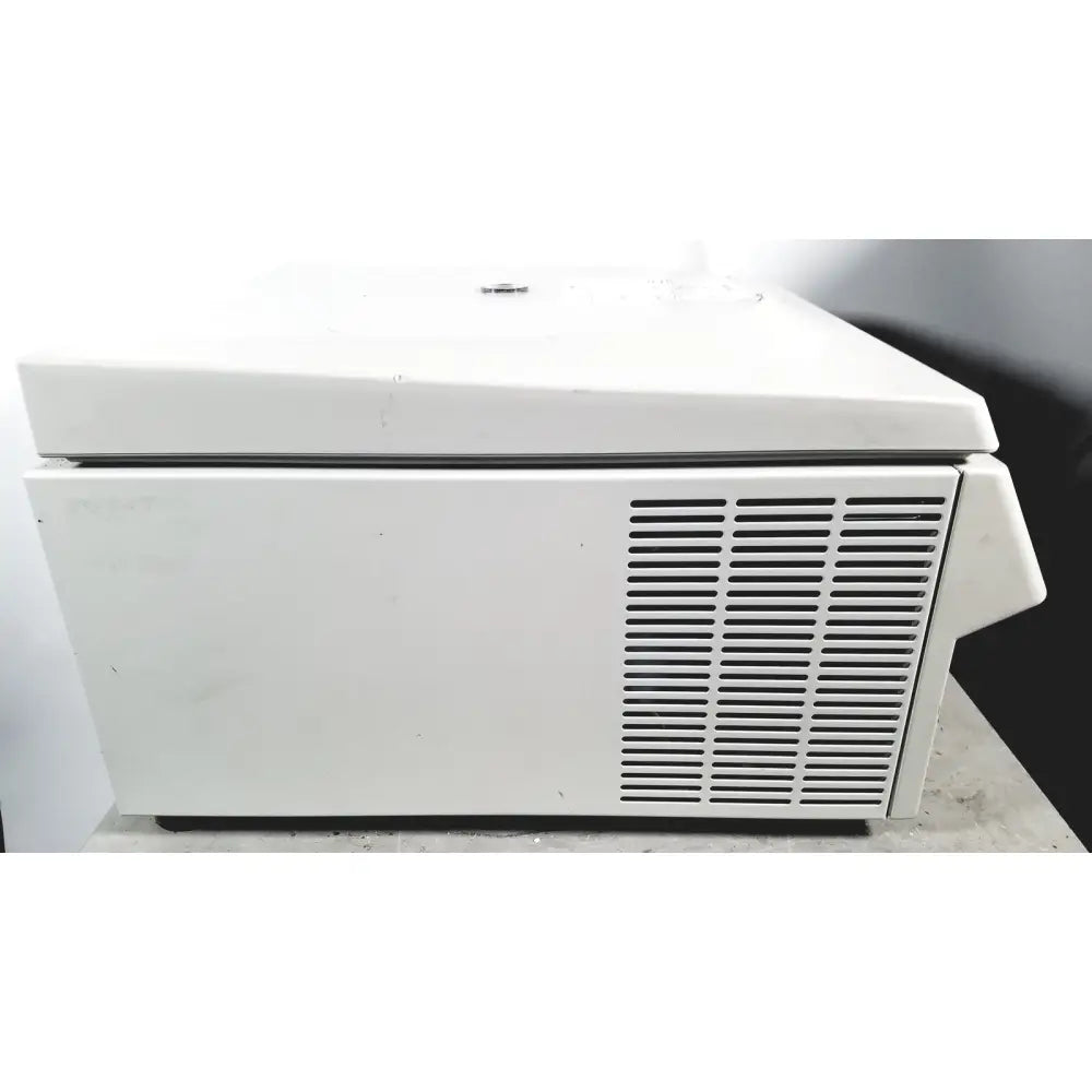 White laboratory eppendorf centriifuge model 5810 with hinged lid and vertical ventilation slats for reuse medical applications
