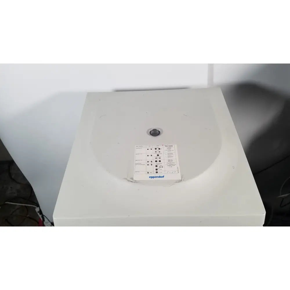 White plastic eppendorf centriifuge model 5810 with circular lid and control panel for laboratory use