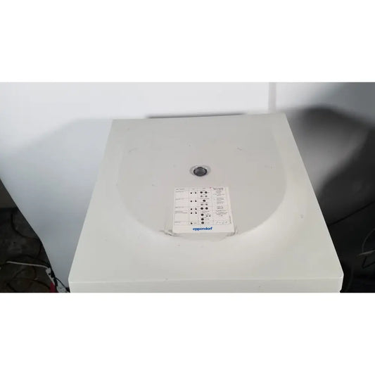 White plastic eppendorf centriifuge model 5810 with circular lid and control panel for laboratory use