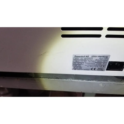 White plastic appliance label with black text on the back of eppendorf centriifuge model 5810 showing manufacturer and specs