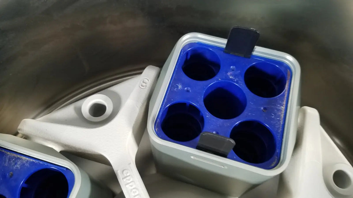 Blue and gray plastic ice cube tray with six circular compartments for reuse medical applications in eppendorf centriifuge model 5810