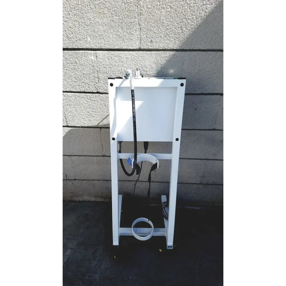 White metal toilet tank mounting bracket with black hoses and white pipe shown on the back side of erbe erbokryo cryosurgical unit 30448-014