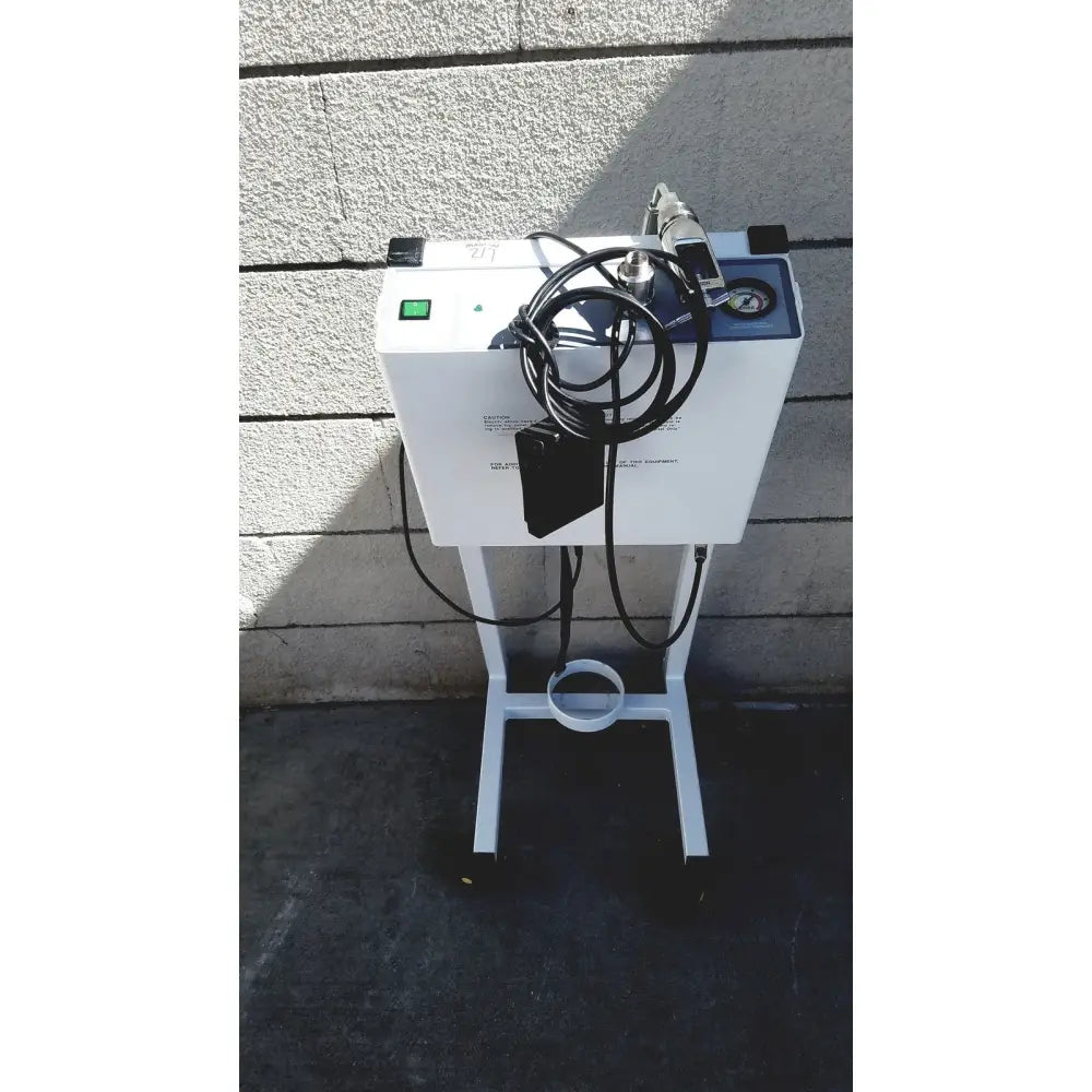 White medical-grade oxygen concentrator with black tubing and pressure gauge on wheeled stand for erbe erbokryo cryosurgical unit