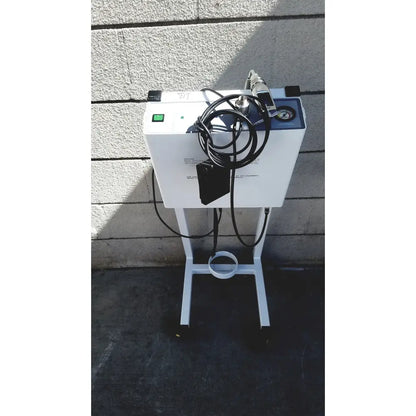 White medical-grade oxygen concentrator with black tubing and pressure gauge on wheeled stand for erbe erbokryo cryosurgical unit
