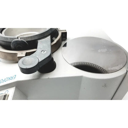 Gray metallic microscope stage with black adjustment lever and circular sample holder in Erkodent Erkoform-RVE dental lab thermoforming system