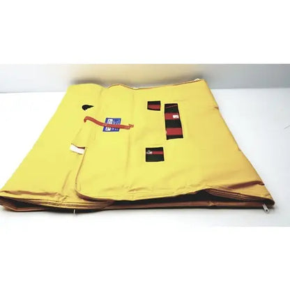 Yellow fabric evacuation sled mobility device with red and black rectangular patches for emergency patient evacuation