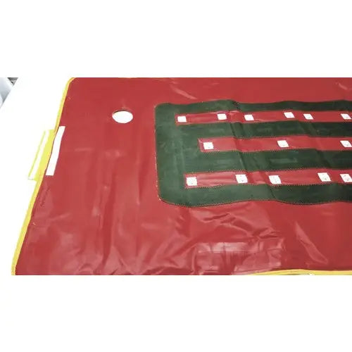 Red vinyl patient evacuation sled with green and white striped pattern for emergency patient evacuation mobility